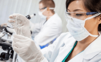 Laboratory professional preparing a specimen for pre-employment drug testing as part of employee screening and onboarding.